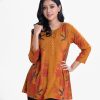 Women's A-line tunic in viscose fabric. U-neck with metal buttons placket, three quarter sleeves.