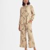 Floral printed A-line top bottom set in satin fabric. Clssic collar with frill trims at the front. three-quarter sleeved and hight low hem top and palazzo pant.