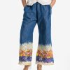 Women's printed palazzo in denim fabric. Concealed elasticated waistline and two side pockets.