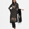 Printed salwar kameez in crepe fabric. Boat neck, three-quarter sleeves and embroidery at front of kameez. Half-silk dupatta with pant-style pajamas.