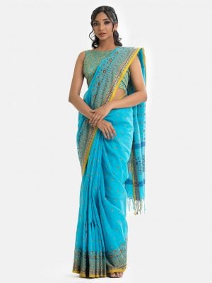 Printed saree in cotton fabric. Embellished with karchupi and fringe trim at the border of anchal.