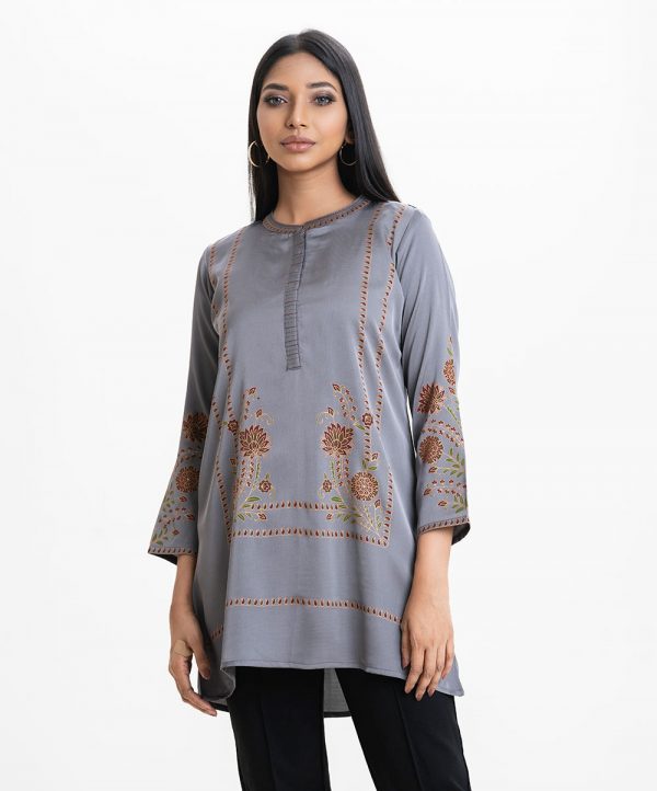 Women's floral printed A-line tunic in crepe fabric. Line stitching at stand collar and placket, full sleeves.
