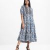 Women's flared style Maxi in printed georgette fabric. High collar, short puff sleeves, gathered waistline. Embroidery and patch at front.