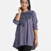 Geometric printed A-line tunic in crepe fabric. Mock neck, lantern sleeves. Karchupi at the front.