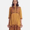 Printed frock-style long tunic in crepe fabric. Stand collar, three-quarter sleeved. Karchupi at the front and box pleated at the waistline.