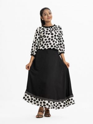 Printed skirt top set in georgette and crepe fabric. The ball printed balloon tops is round neck with pleats, puff-sleeve, and elasticated at the hemline. The skirt is elasticated at the waistline with zipper fly. Attached patch at the hemline.