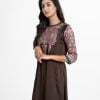 Women's A-line tunic in zoom fabric. Round neck, three-quarter sleeved. Karchupi at the front and attached patch at the hemline.