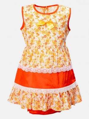 Sleeveless tent-style newborn baby girls frock in cotton fabric. All-over floral printed with lace work at the waistline and hemline. and attached ribbon bow. Completed with baby pants.