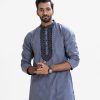Men's fitted panjabi in Jacquard cotton fabric. Embroidery at mandarin collar with metal buttons on the placket.