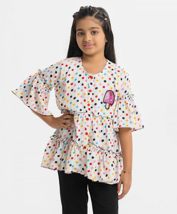 Kids girls A-line polka dot printed tiered pattern tunic in georgette fabric. Round neck, bell-sleeved and attached patch at the top front.
