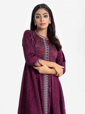 Women's floral printed A-line tunic in crepe fabric. Stand collar, three-quarter sleeves. Patch with embroidery at the front.