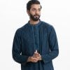 Men's slim-fitted panjabi in jacquard cotton fabric. Mandarin collar with metal buttons on the placket. Embroidery at front.