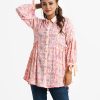 Floral printed shirt style abaya tunic in zoom fabric. Ballon sleeves with bow tie belt and classic collar with metal buttons in front opening. Frill trim at waistline.