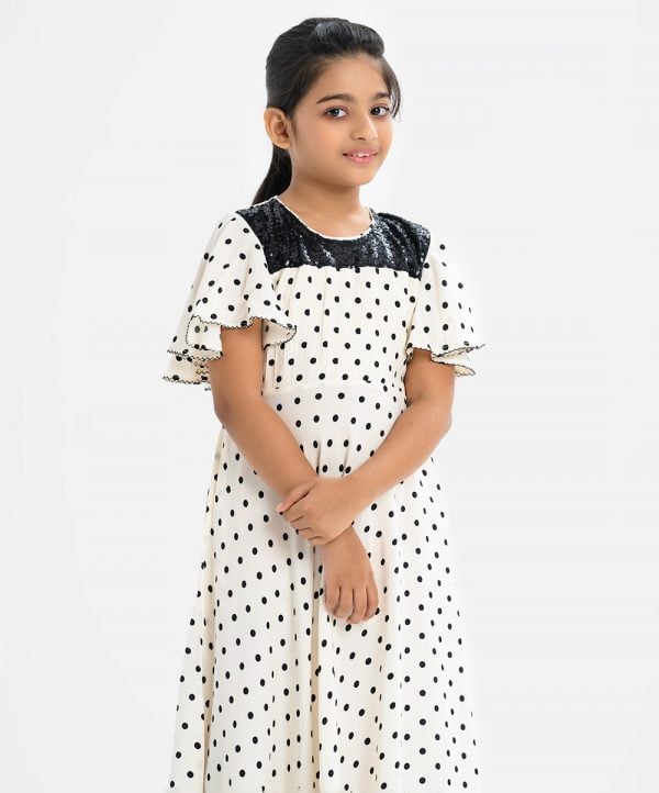 Kid girls A-line polka dot printed frock in georgette fabric. Round neck, butterfly-sleeved. Sequence cut work at the top front.