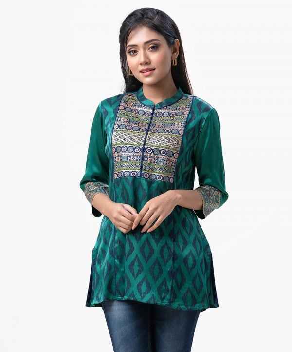 Exclusive printed tunic from Nargisus by Le Reve. Green tunic in silk & viscose blended fabric. Three-quarter sleeved, band neck and karchupi at the front.