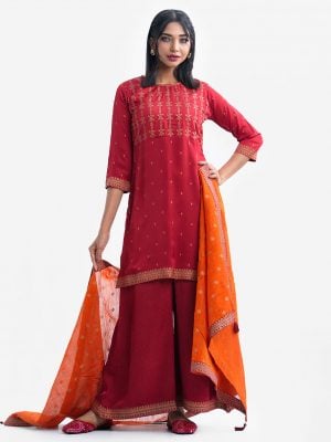 Women's printed straight salwar kameez in crepe fabric. Round neck, three-quarter sleeved and karchupi at the front. Complemented with palazzo pant and silk dupatta.