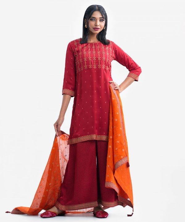 Women's printed straight salwar kameez in crepe fabric. Round neck, three-quarter sleeved and karchupi at the front. Complemented with palazzo pant and silk dupatta.
