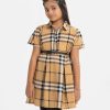 Kid girls A-line tunic in georgette fabric. Classic collar, short-sleeved. Box pleated at the waistline with a waist-belt.