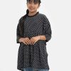 Kid girls polka dot printed short tunic in georgette fabric. Round neck with attached lace, batwings sleeved and gathered at the waistline.