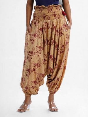 Women's floral printed harem pants in viscose fabric. Wide smocked waistline for a better fit. Pocket at sides.