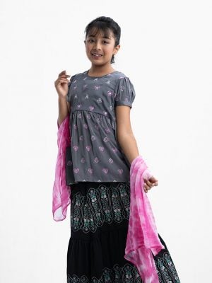 Kid girls ghagra choli in crepe fabric. Round neck, puff-sleeved and karchupi at the front. Competed with A-line skirt and tie dye dupatta.