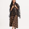 Teen girl's shrug style top-bottom set in organza fabric. Sleeveless karchupi detail top with karchupi assembled patch collar open front shrug. Printed palazzo pants as the bottom.