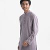 Teen boys panjabi in jacquard fabric. Mandarin collar, full-sleeved. Inseam pockets and button fastening at the front.