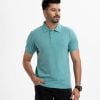 Men's short-sleeved polo in bubble knit fabric. Classic collar and straight-cut hem.