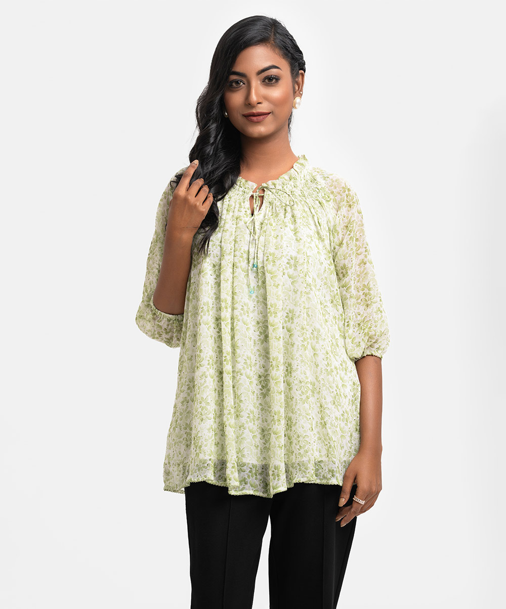 Women's A-line tops in printed georgette fabric with viscose lining. Frill neck with smocked design and tassel tie, bishop sleeves. Green Georgette A-line Top