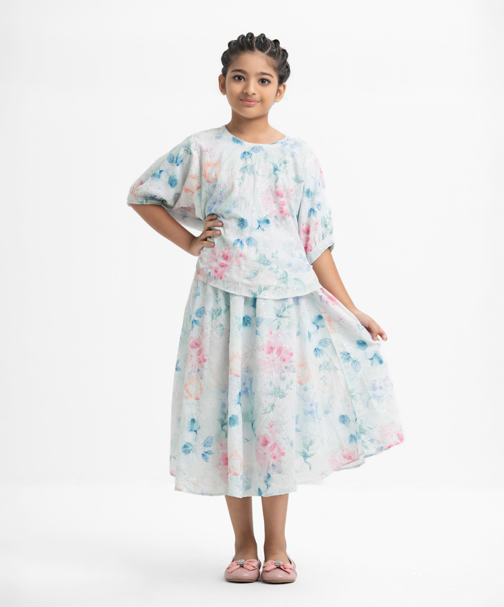 Kid girls' floral printed woven set in georgette fabric with cotton lining. Bat-wing sleeves, round neck, and all over sequin details on the top.Comes with a matching skirt at the bottom. White Georgette Woven Set