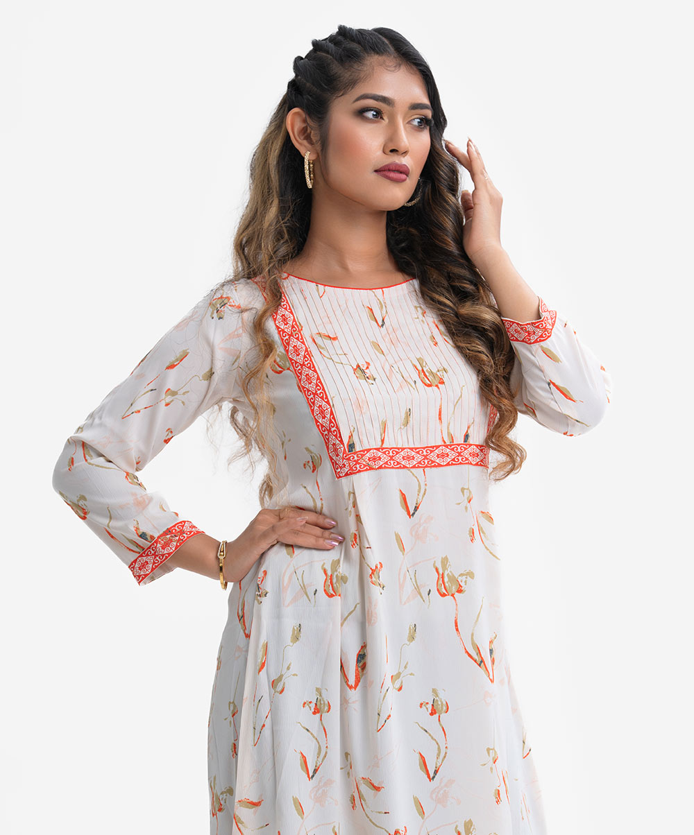 Women's A-line tunic in printed joom fabric. Round neck, full sleeves. Patch and pin tuck at front. Frill hemline. White Joom A-line Tunic