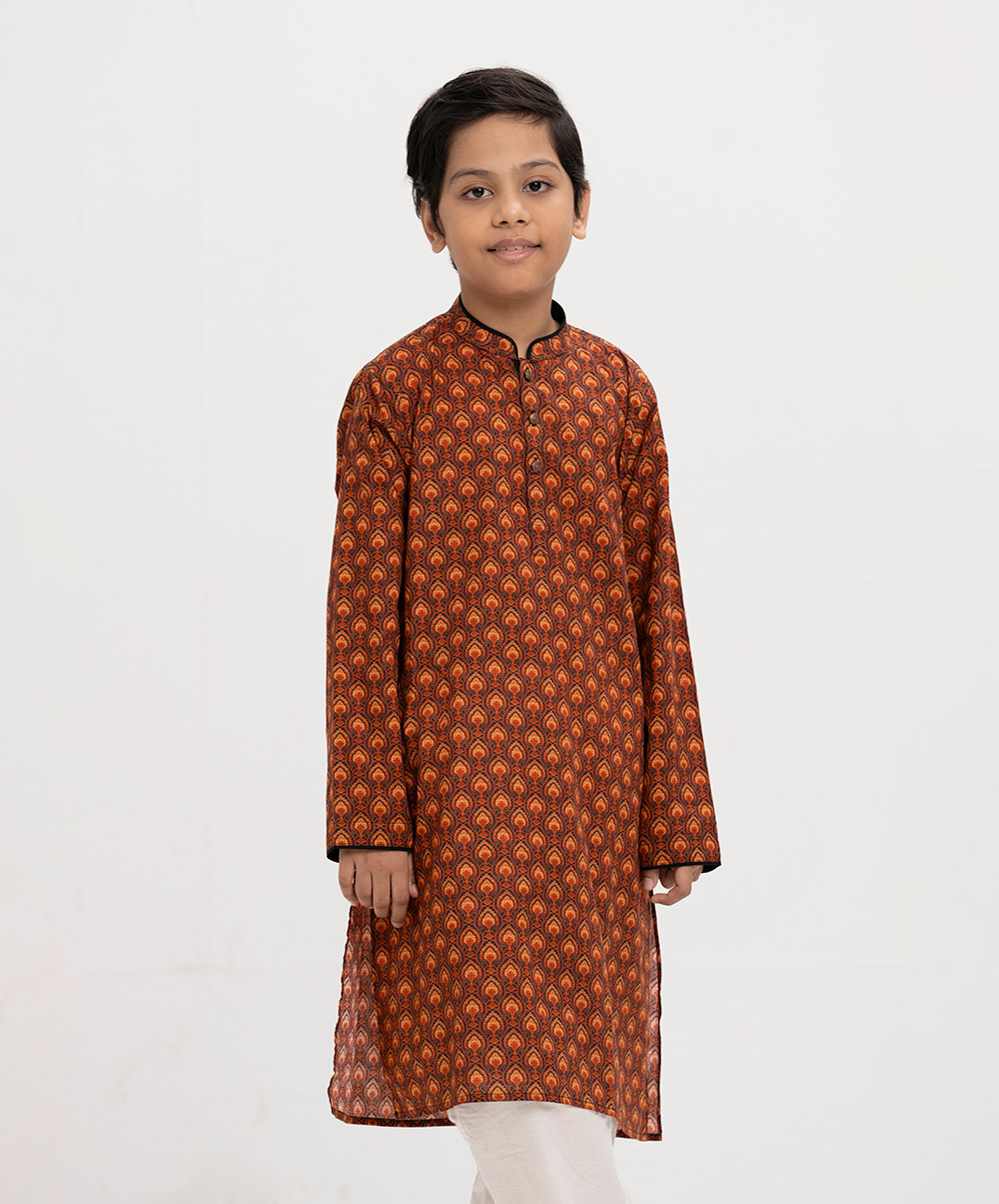 Kid boy's panjabi in printed cotton fabric. Mandarin collar, buttons placket & full sleeves. Inseam pockets. Orange Cotton Printed Panjabi