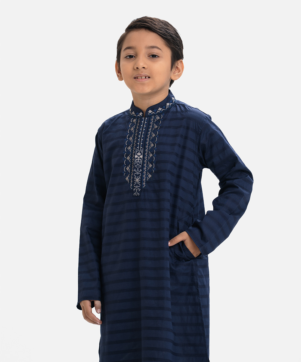 Kid boy's panjabi in cotton jacquard fabric. Mandarin collar & full sleeves. Embroidery at front & inseam pockets. Blue Cotton Jacquard Panjabi