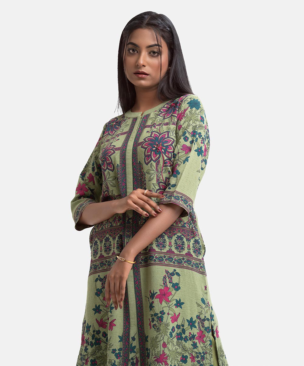 Women's floral printed A-line tunic in stretchable georgette fabric. Stand collar, three-quarter sleeves. Karchupi at front and inseam pockets. Mint Stretchable Georgette A-line Tunic