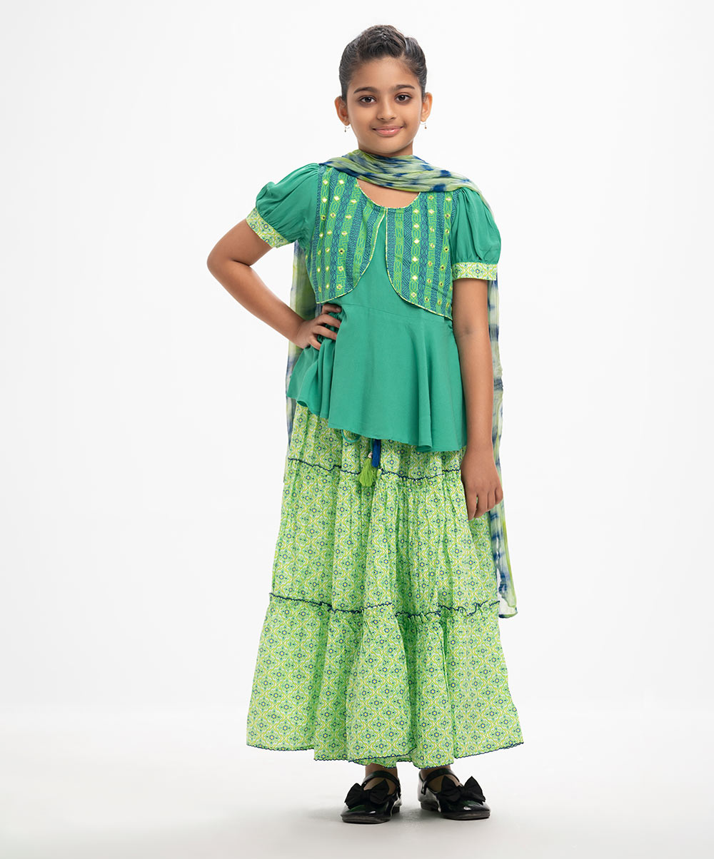 Kid girls printed koti style ghagra choli set in viscose fabric. Puff sleeves, round neck, and embroidery at the front of the top. A tie-dye chiffon dupatta with a tiered skirt. Green Viscose Ghagra Choli
