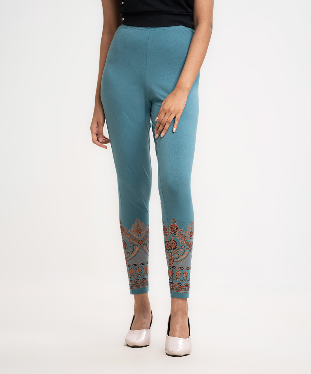 Women's leggings in stretchable cotton knit fabric. Concealed elasticated waistline and print at cuff. Teal Cotton Knit Leggings