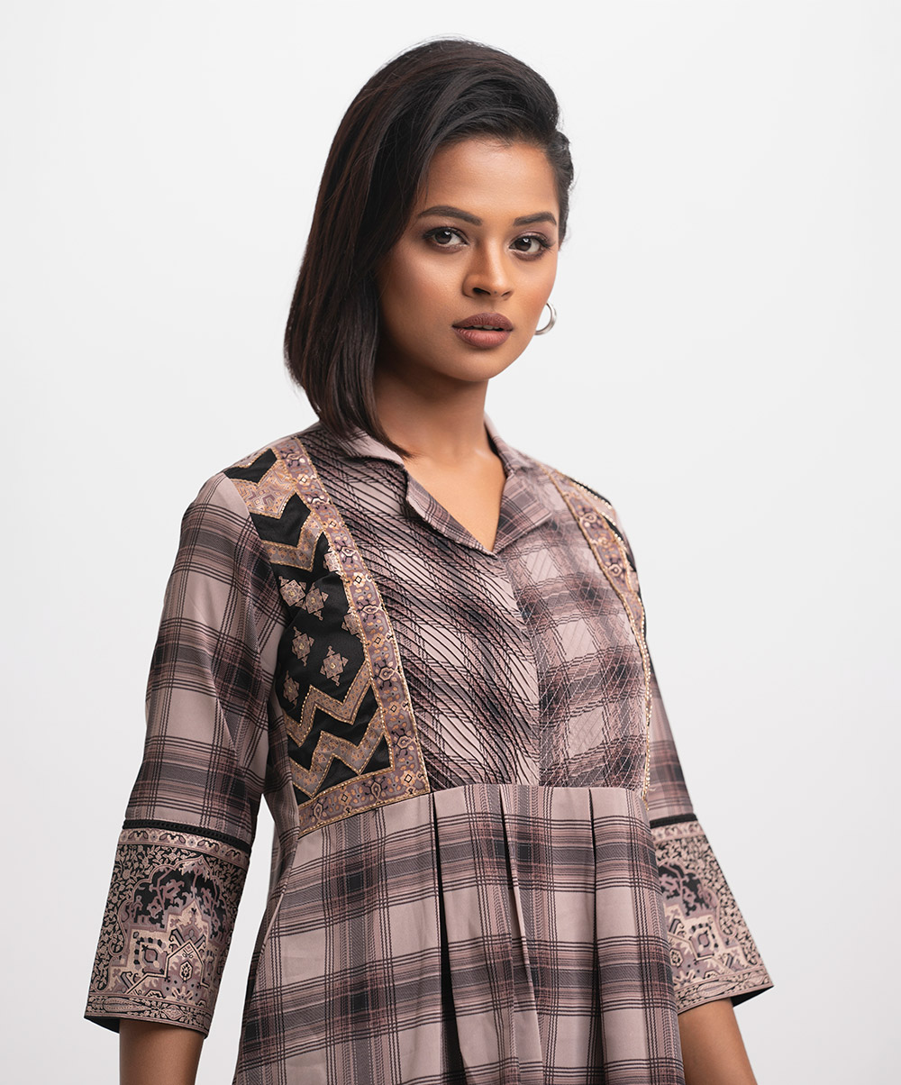 Lapel collar A-line tunic in check faille fabric. Box pleated, pintuck and karchupi details at the front. Mauve Faille A-line Tunic