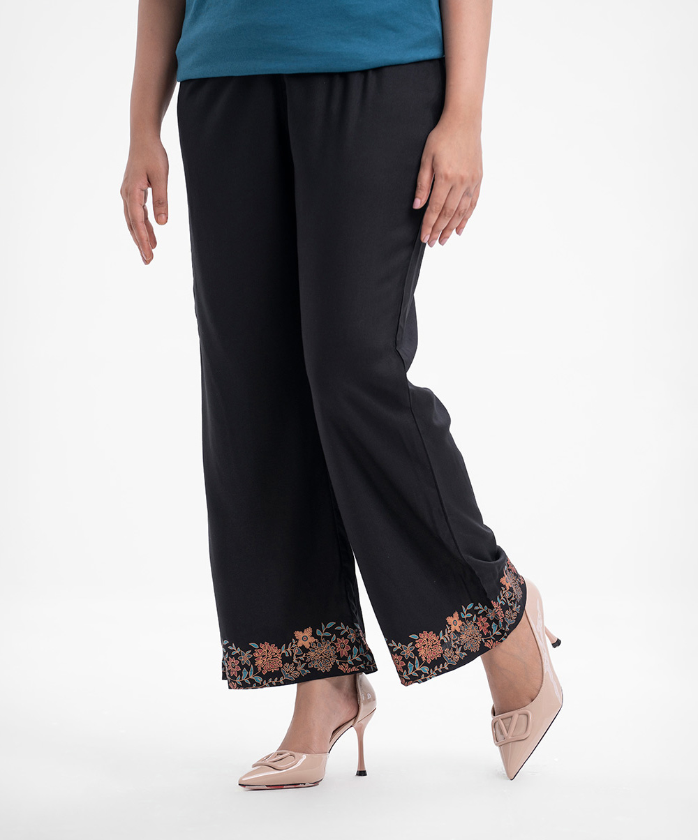 Women's regular wear comfortable palazzo in viscose fabric. Concealed elasticated waistline and print detail at ankle line. Black Viscose Palazzo
